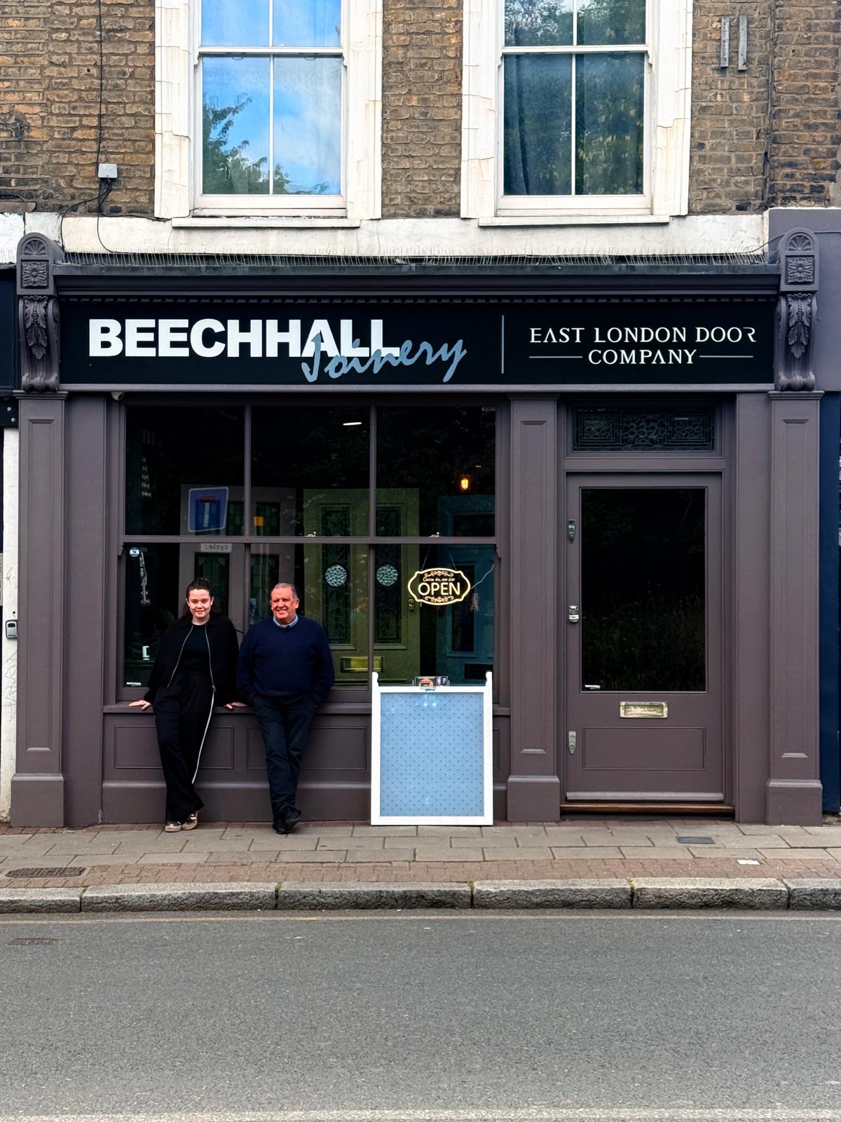The Beechhall Joinery shopfront on Hackney Road, East London, an aubergine-painted frontage with the East London Door Company sign and the team standing outside.