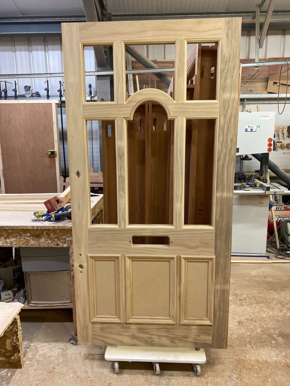 A traditional glazed pine door bench-built and ready for finishing in Beechhall Joinery's East London workshop.